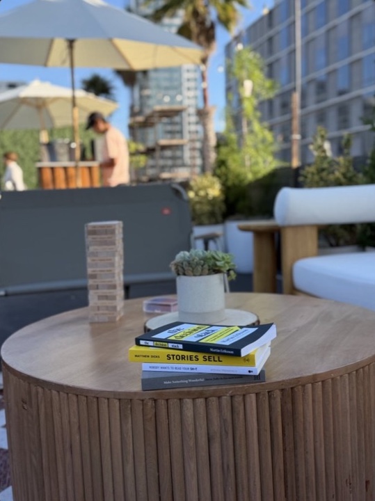 Books and a game on a table in the outdoor lounge