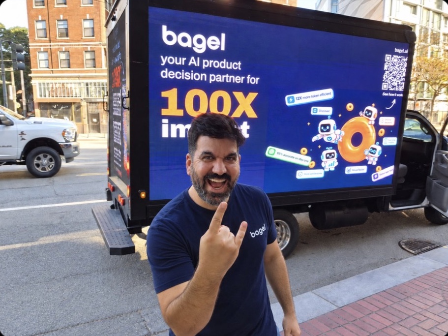 A playful attendee photo outside beside the Bagel truck