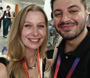 Two smiling attendees together at the Summit