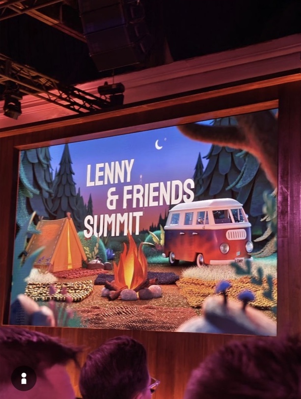 The campfire backdrop glowing above the gathered audience