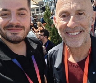 Two smiling attendees in an outdoor selfie