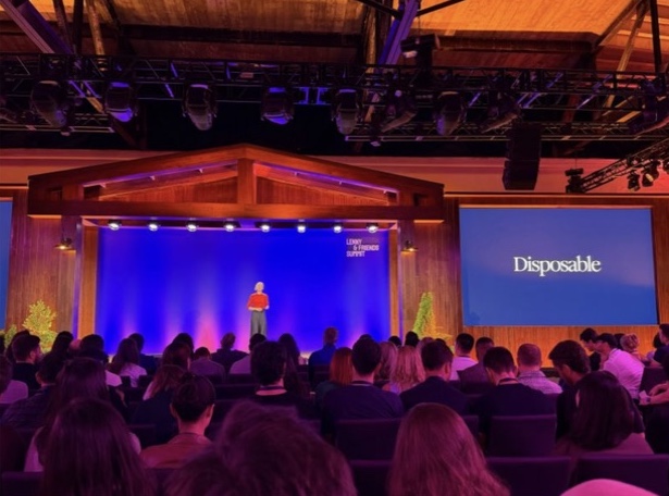 Attendees gathered for a talk in the warmly lit hall